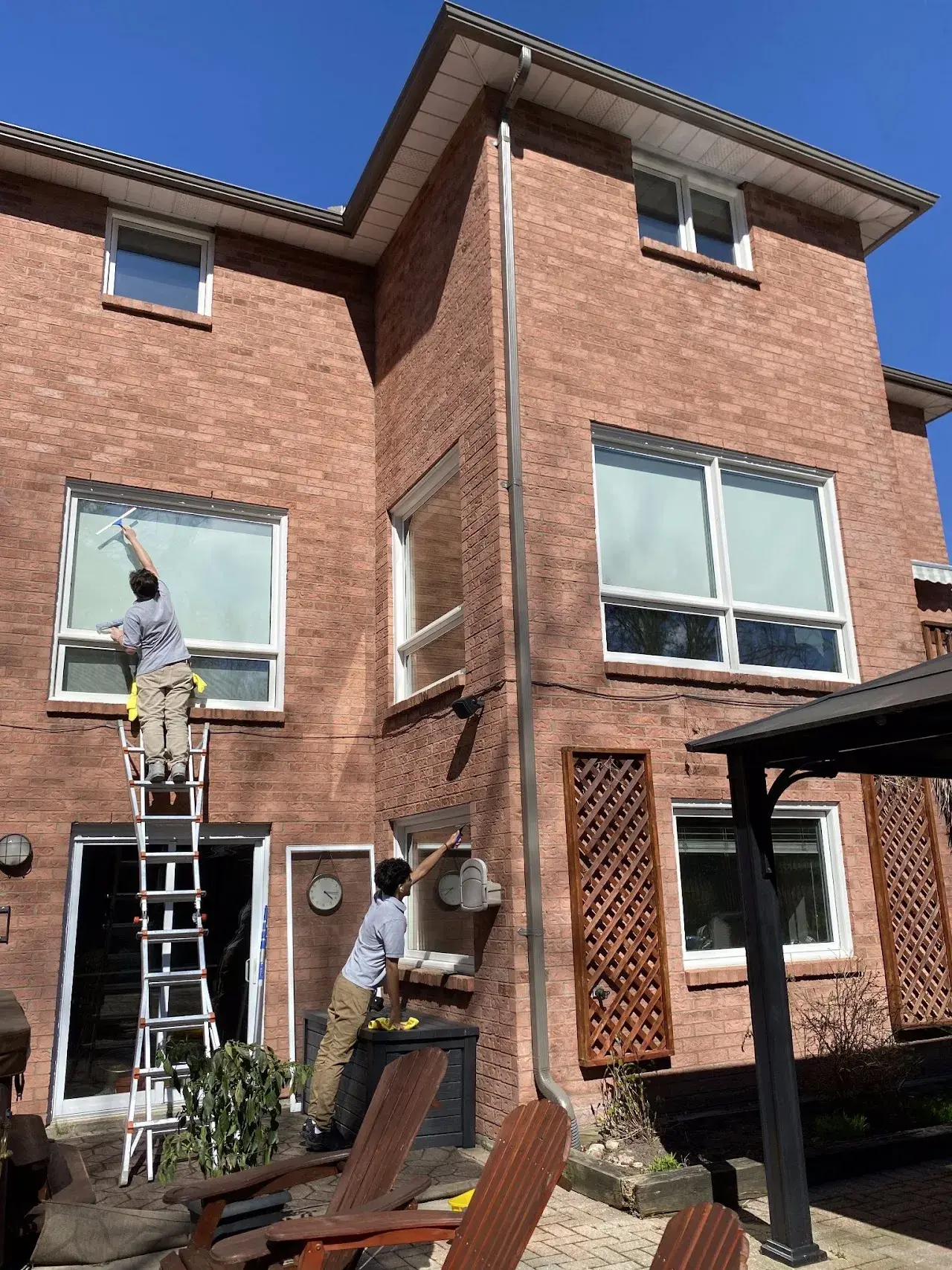 Exterior window cleaning crew working as a team